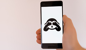 phone screen with a cartoon monkey covering its eyes